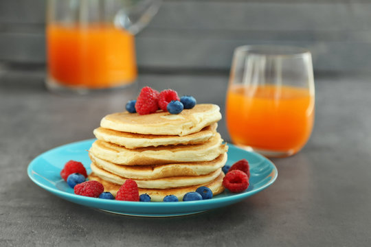 Plate full of tasty pancakes with berries
