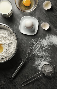 Ingredients for making cake on grey background, top view