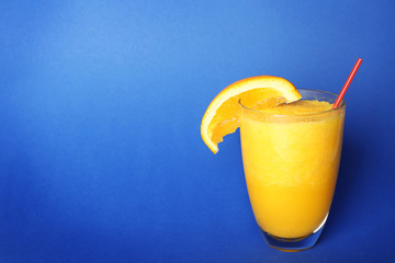 Orange smoothie on color background