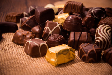 Assorted chocolates on wooden background