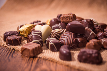 Assorted chocolates on wooden background