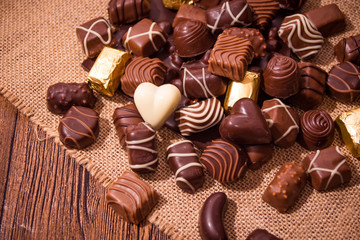 Assorted chocolates on wooden background