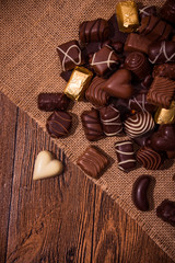 Assorted chocolates on wooden background