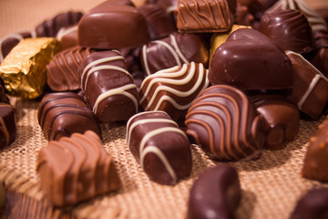 Assorted chocolates on wooden background