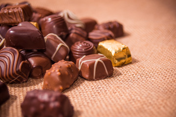 Assorted chocolates on wooden background