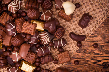 Assorted chocolates on wooden background