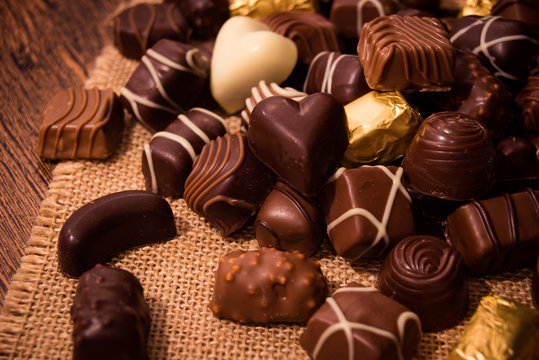 Assorted chocolates on wooden background