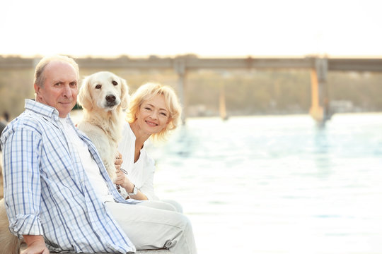 Senior couple and big dog on bund