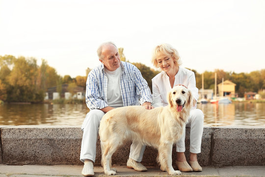 Senior couple and big dog on bund