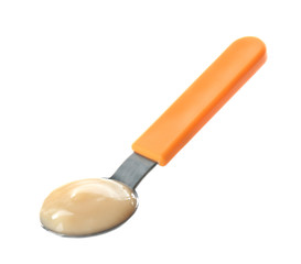 Bright spoon with baby puree on white background