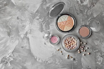 Decorative cosmetic set on grey textured background
