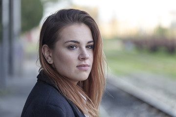 Teenager waiting for a train at the station