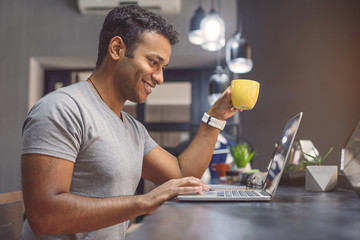 African man studying in cafe