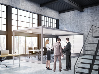 People standing in open office with aquarium meeting room