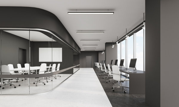 Long conference room in office with row of workstations