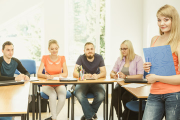 Student girl in front of her mates in classroom