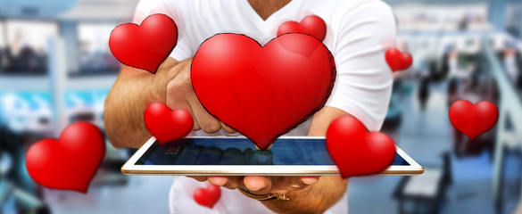 Young man holding hand drawn red heart