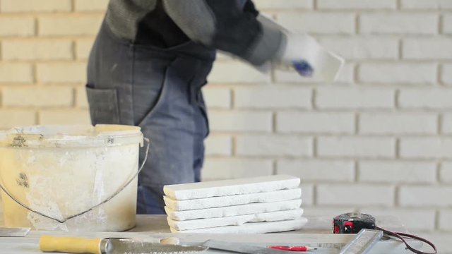 man preparing bricks for wall instalation