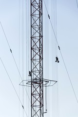 Men painting the highest Czech construction radio transmitter tower Liblice