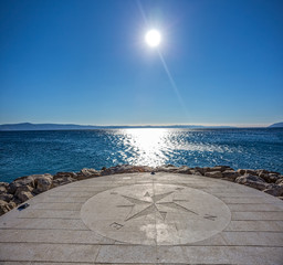 Compass by the sea