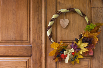 A wreath of autumn leaves decorate the doors
