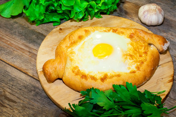 Adjara khachapuri bread on a board with cheese
