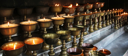  Charity. Praying candles in a temple.