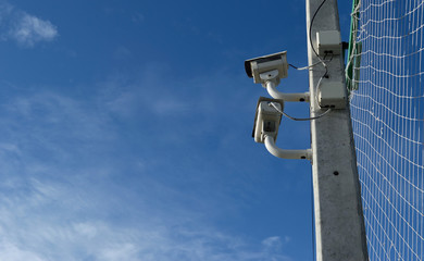 Security camera on blue sky background. Installed in the footbal