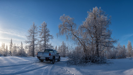 car in the winter forest © Andrey Snegirev