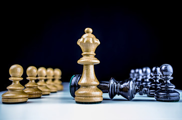 Chess figures symbolize victory and defeat