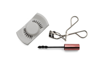 Mascara, fake eyelashes and eyelash curler isolated on white background from top view