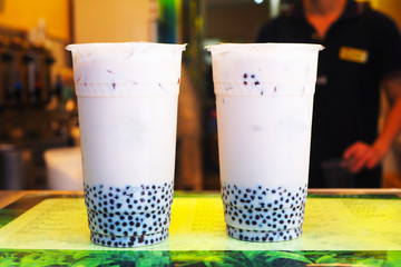 Close up of iced milk bubble tea with tapioca pearls.