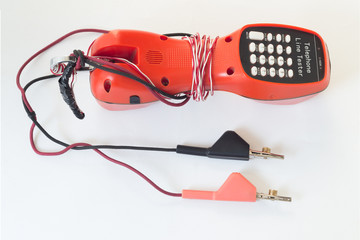 Telephone line tester on white