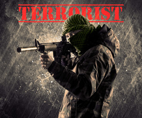Dangerous masked and armed man with terrorist sign on grungy bac
