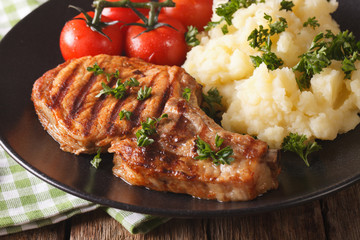 Grilled pork steak with mashed potatoes close-up. Horizontal