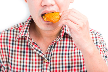 Man eating roasted chicken wings