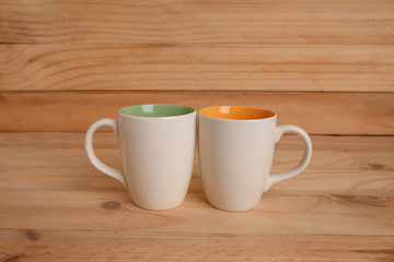 Cup of coffee on a wooden table and nature background.