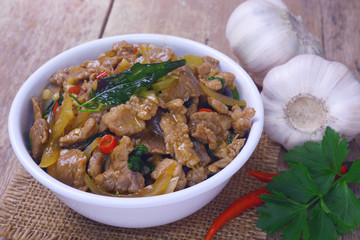 Stir fried hot and spicy sauce with pork, crispy basil leaf on top, served together with aromatic jasmine rice, an authentic popular traditional Thai food.