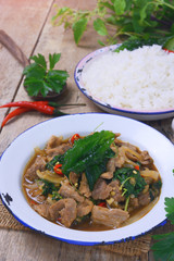 Stir fried hot and spicy sauce with pork, crispy basil leaf on top, served together with aromatic jasmine rice, an authentic popular traditional Thai food.