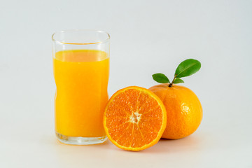 Orange juice and slices of orange isolated on white