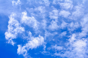 Blue sky background with white clouds. The vast blue sky and clouds sky on sunny day. White fluffy clouds in the blue sky.