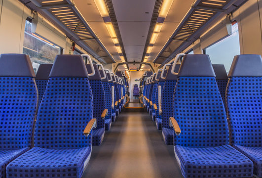 Fototapeta Empty train chairs - Image with the interior of a german modern train, with no people on the blue chairs