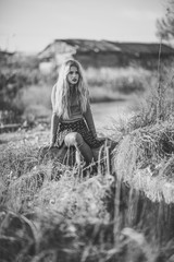 Beautiful young blonde woman in rural background