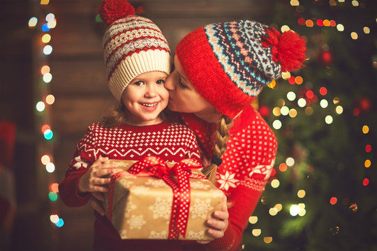 Happy family mother and child girl  with Christmas present
