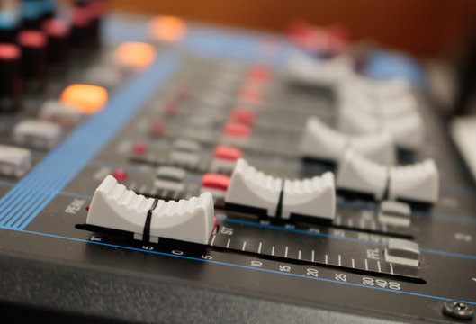 Mixer in recording room. Closeup button to increase or decrease