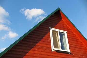 Plastic window of a modern summer cottage against a blue sky