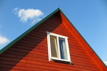 Plastic window of a modern summer cottage against a blue sky