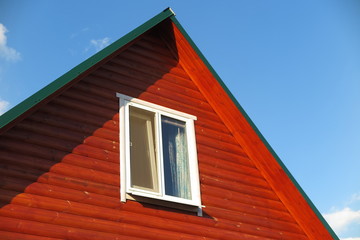 Plastic window of a modern summer cottage against a blue sky