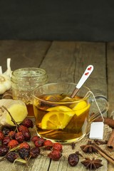 Natural treatment for colds and flu. Ginger lemon honey garlic and rosehip tea against influenza. Hot tea for colds. Home Pharmacy. Proven treatment of diseases. Folk medicine.

