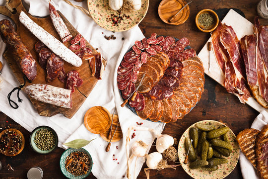 Charcuterie and cured meat cutting board. Lomo, jamon, chorizo, salchichion, fuet and sausage cuts. 